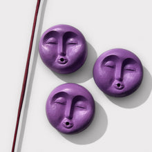 Load image into Gallery viewer, Three purple concrete incense holders in the shape of moons, displayed in a row with a cork backing and a sealed finish.